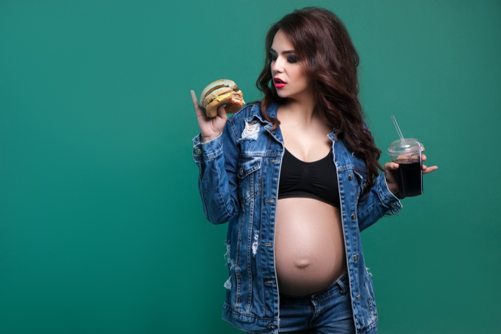 Pregnant woman with fast food