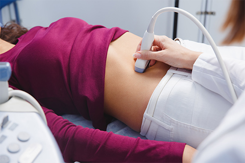 Physician conducting ultrasound on a woman